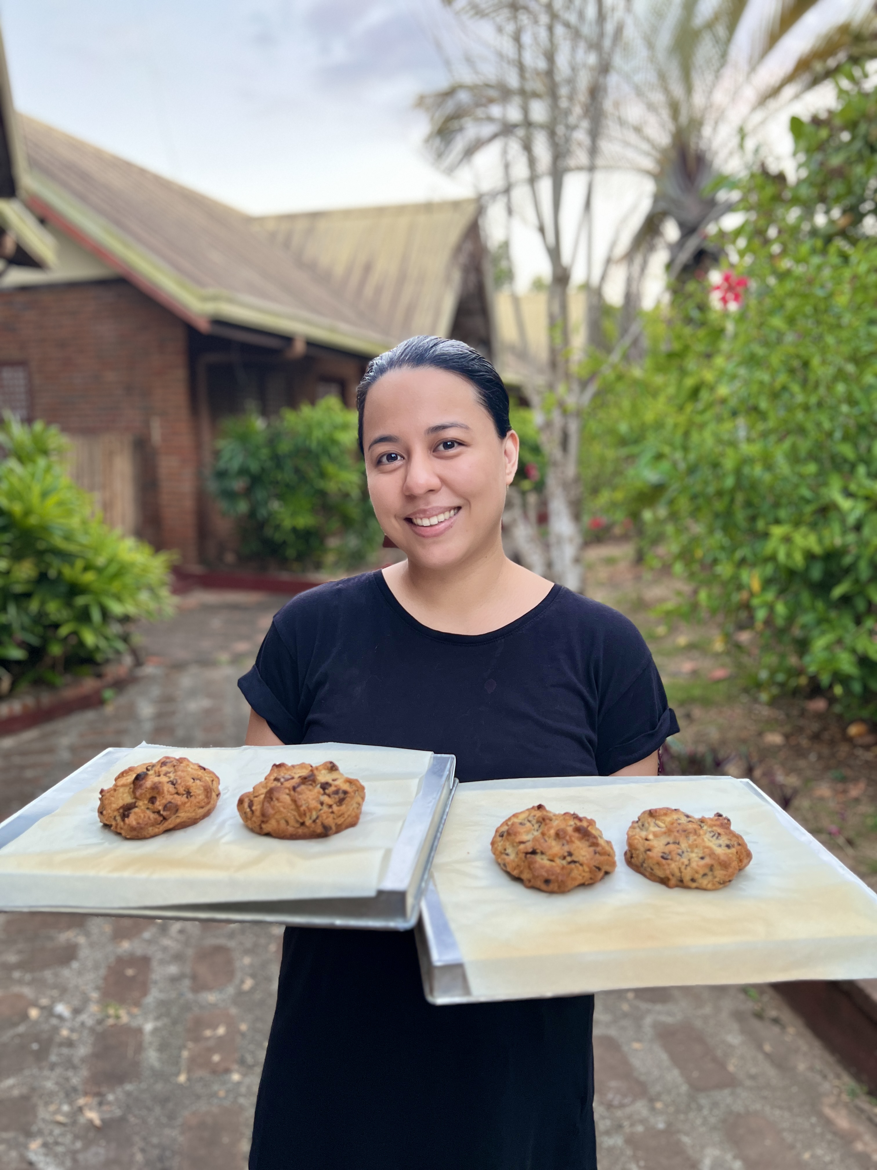 Nikki holding trays of freshly baked Griddle! cookies